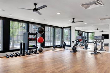 a gym with windows and weights and other exercise equipment